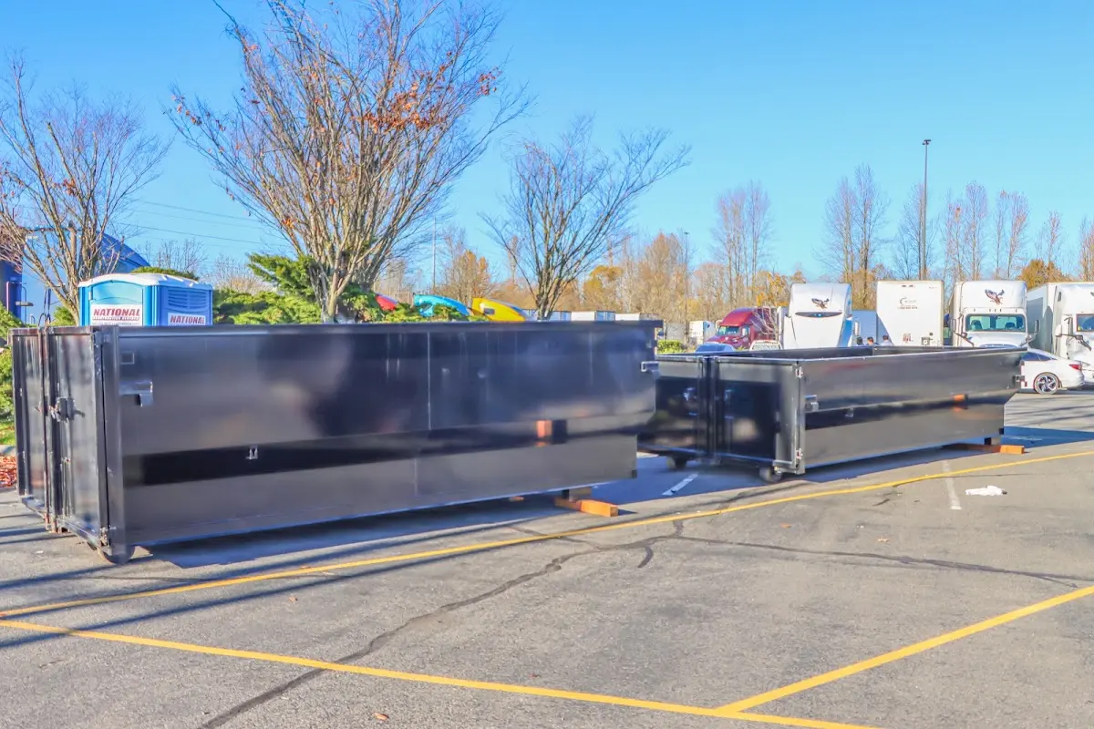 Professional dumpster rental service with roll-off container on residential driveway in Western Springs